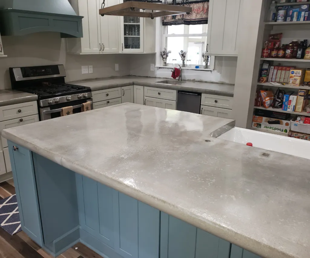 Kitchen island with a gray countertop and white cabinets