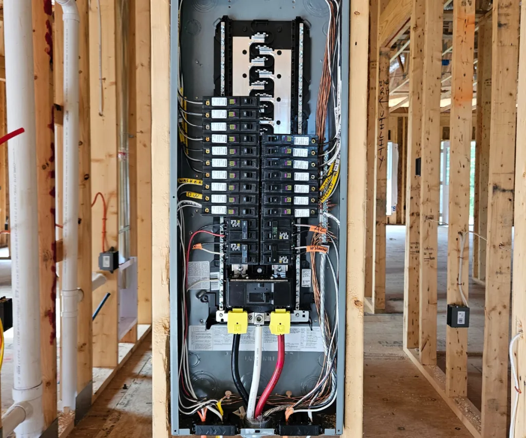New breaker panel wired and labeled in open wall framing